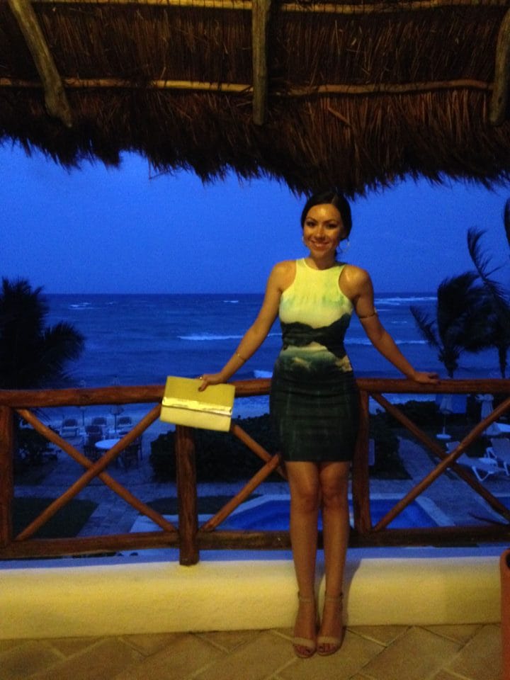 Nihan Gorkem showing her outfit of the night, an ocean printed dress, in Tulum Mexico
