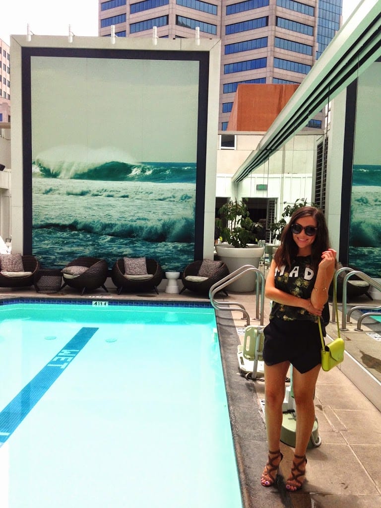 Blogger Nihan showing her black and green fun summer brunch outfit by the pool at the W Hotel in San Diego