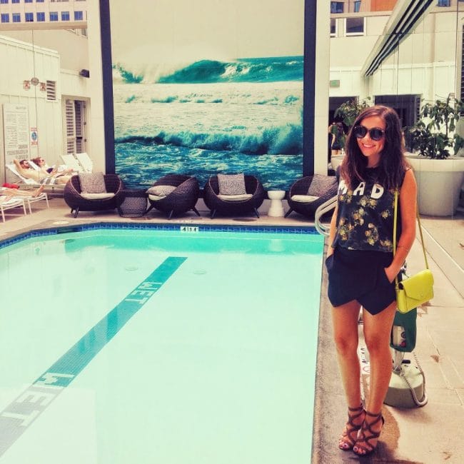 Blogger Nihan showing her black and green fun summer brunch outfit by the pool at the W Hotel in San Diego