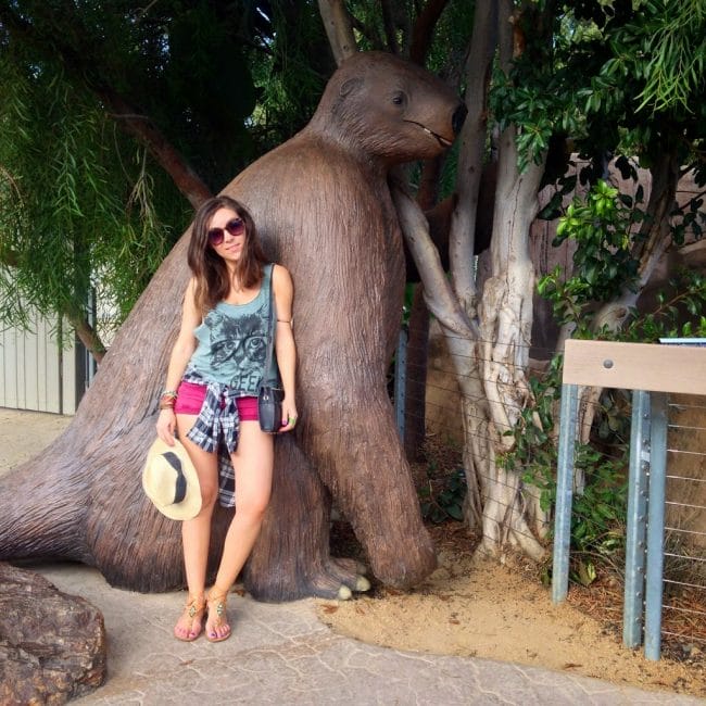 Blogger Nihan posing with the sloth and showing her outfit at the San Diego Zoo