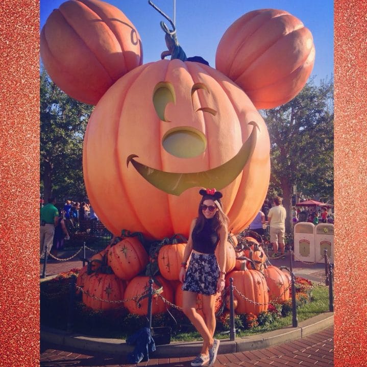 Blogger Nihan posing in front of the huge  Mickey Pumpkin in Disneyland during Halloween Time