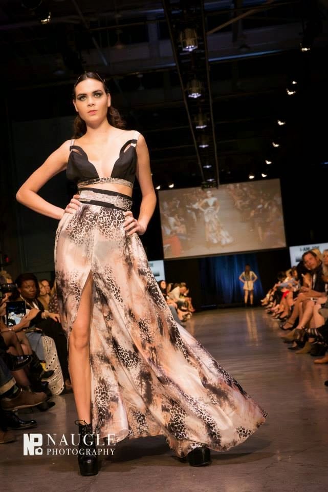 Model wearing a sexy, black and nude  maxi dress with cutouts on Fashion Week San Diego Night 3
