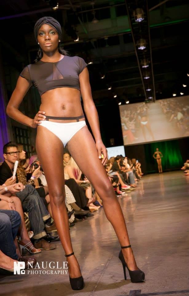 Model wearing a black and white bikini walking down the runway during Fashion Week San Diego 2014 Night 3
