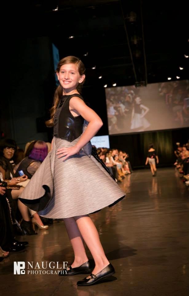 Pretty teenage girl model walking down the runway on Fashion Week San Diego 2014 Night 2