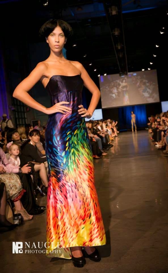 Model wearing a long peacock pattern dress walking down the runway on Fashion Week San Diego 2014 Night 2