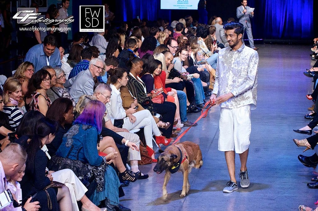 Male Model and a cute puppy from Rancho Coastal Humane Society walking down the runway on Fashion Week San Diego 2014 Night 2