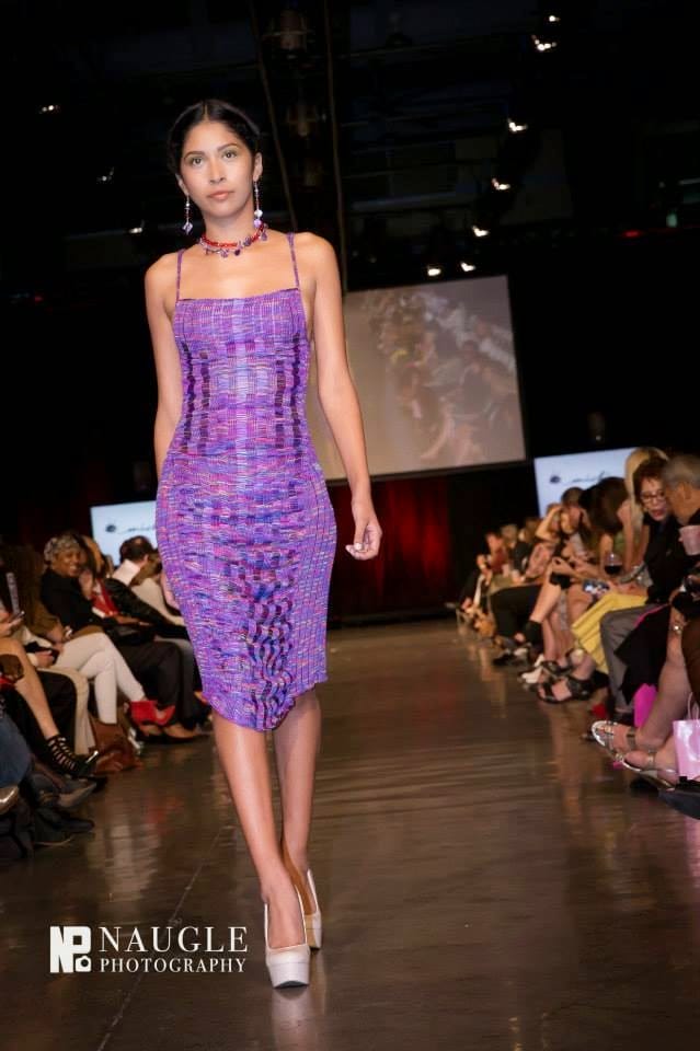 Model in purple dress walking down the runway on Fashion Week San Diego 2014 Night 2