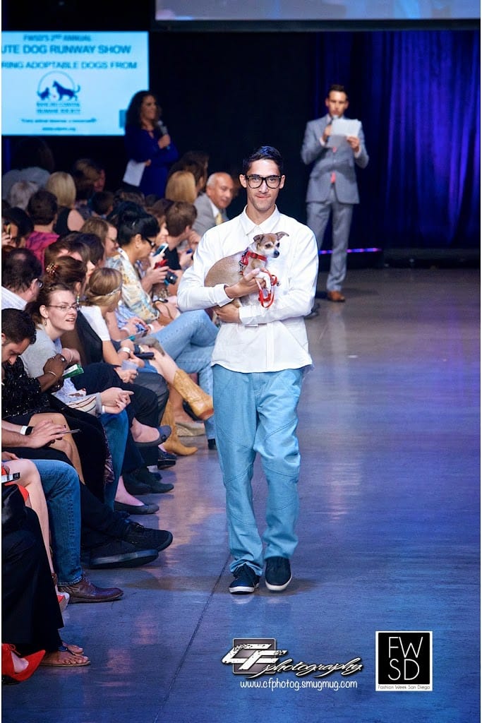 Male Model and a cute puppy from Rancho Coastal Humane Society walking down the runway on Fashion Week San Diego 2014 Night 2