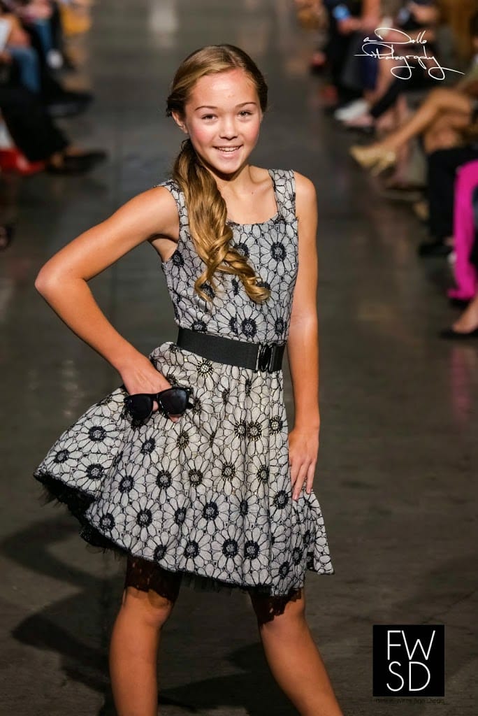 Pretty teenage girl model walking down the runway on Fashion Week San Diego 2014 Night 2