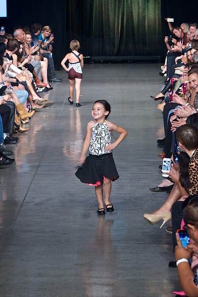 Cute little girl model walking down the runway on Fashion Week San Diego 2014 Night 2