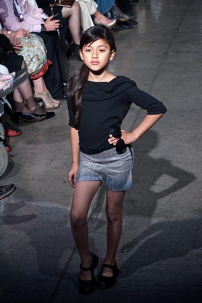 Pretty teenage girl model walking down the runway on Fashion Week San Diego 2014 Night 2