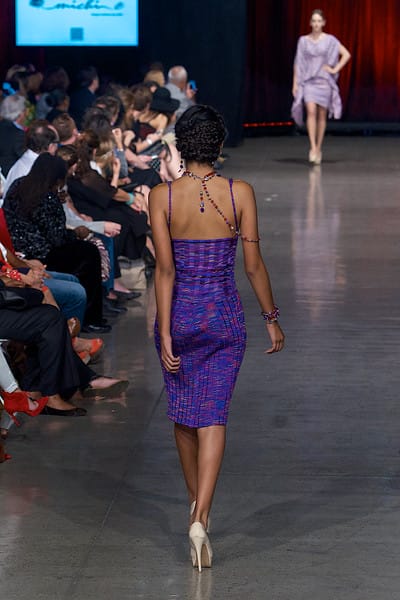 Model in purple dress walking down the runway on Fashion Week San Diego 2014 Night 2