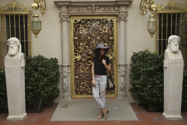 Blogger Nihan wearing gray Floppy Hat, ripped jeans and Topshop Duffel Bag while visiting Hearst Castle
