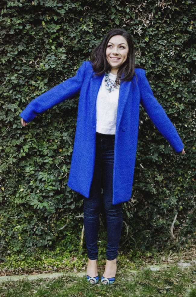 Fashion model wearing an Oversized blue coat and being funny