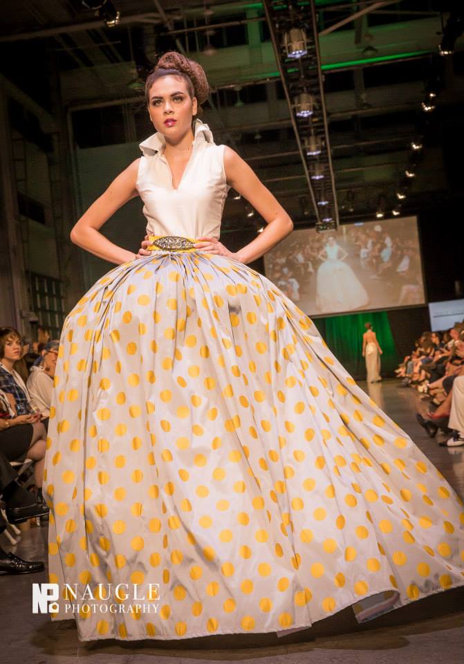 Model wearing a white  and yellow gown with a big fluffy skirt by Dulce Alexandra, Duck and England at Fashion Week San Diego 2014 Night 5: Finale Runway
