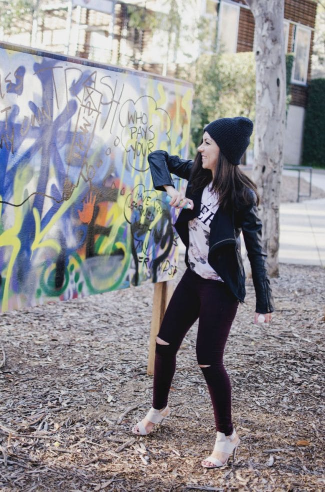 Model painting a graffiti and looking aggressive