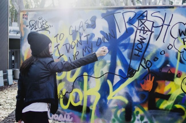 Model painting a graffiti in ucsd graffiti park