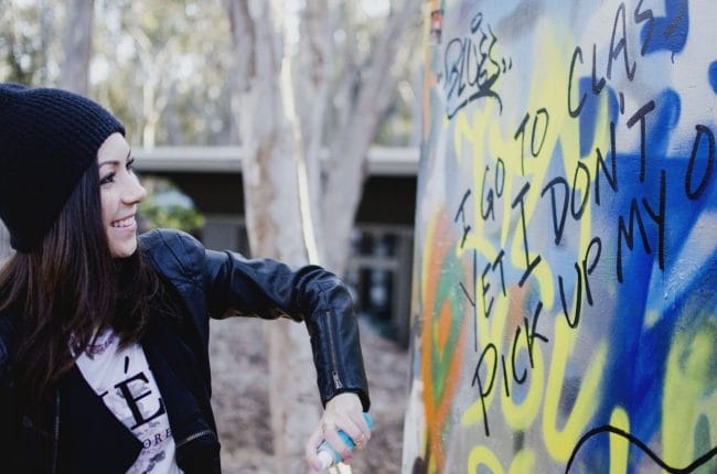 Model painting a graffiti in ucsd graffiti park