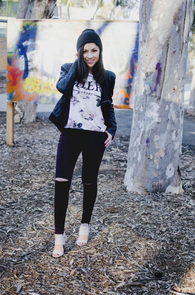 Model posing and showing her outfit in a graffiti park