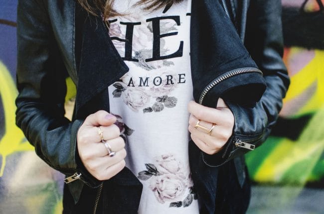 Model showing her outfit details and jewelry