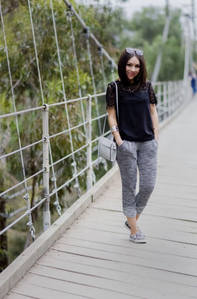 Nihan showing her ootd, grey sweatpants, grey sneakers, black Topshop lace top and white purse