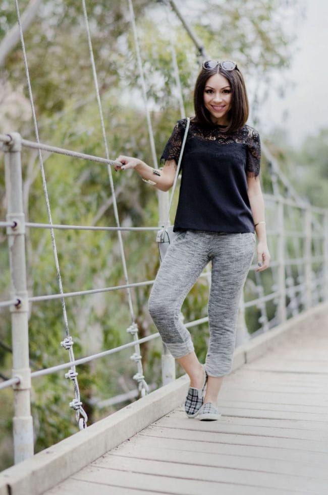 Nihan wearing sweatpants, sneakers and a black lace top at Suspension Bridge