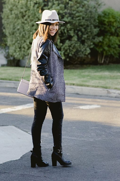Blogger Nihan wearing a grey H&M jacket with black leather sleeves and cool edgy black buckled heeled booties