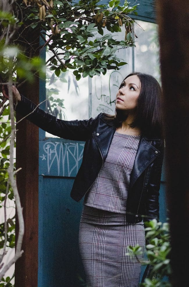Blogger Nihan wearing Topshop grey midi skirt, grey top , black boots and leather Topshop jacket at the Suspension Bridge in San Diego