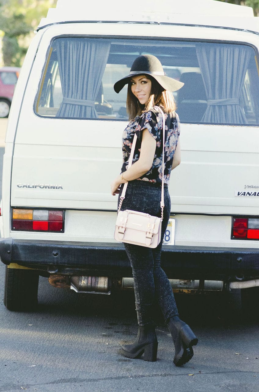 Nihan wearing ASOS floral shirt, H&M floppy hat, jeans, boots and River Island structured bag