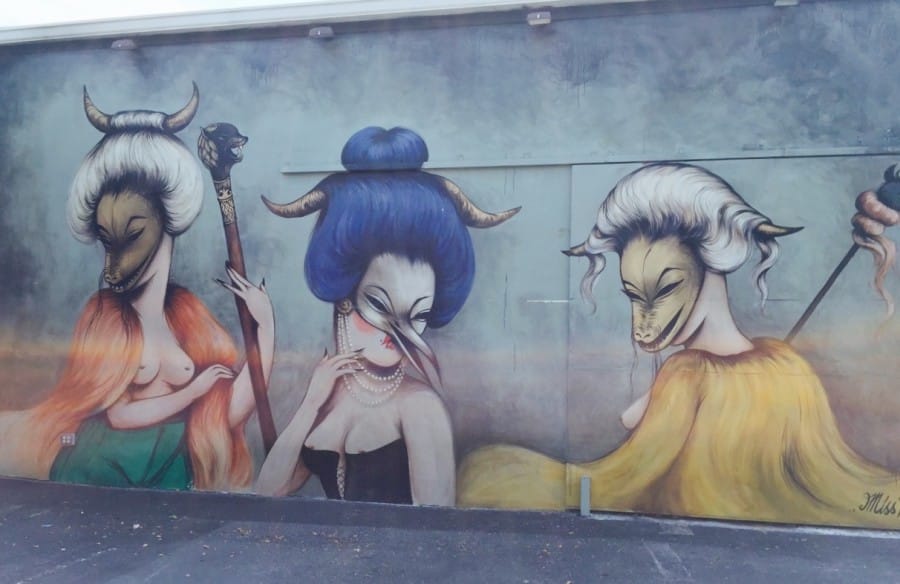 Nihan in front a Miss Van mural in Wynwood Walls, Miami