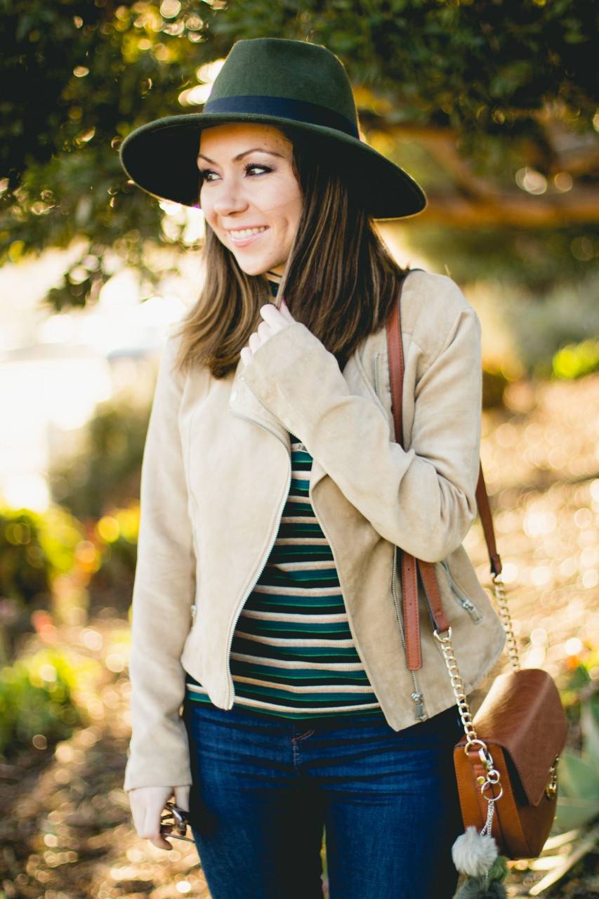 Striped turtleneck top and tan biker jacket