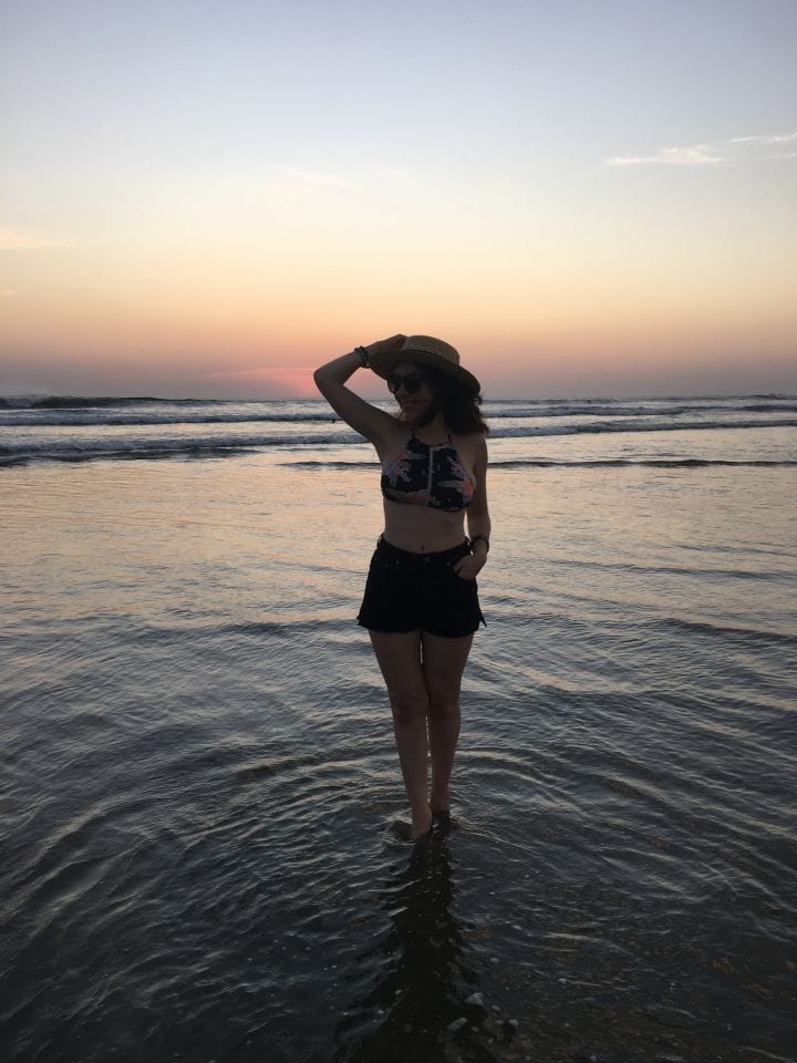 Travel blogger in bikini beach sunset look in Nosara, Costa Rica