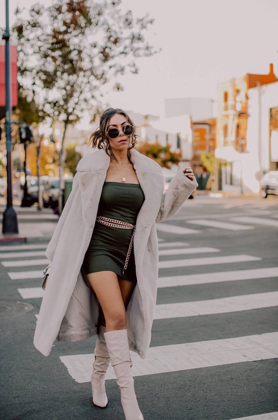 Style blogger wearing Revolve mini knit dress, HM faux fur coat and Public Desire knee high boots